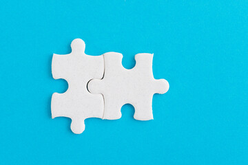 Two puzzle pieces on blue background