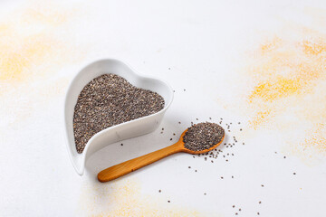 Organic chia seeds in a heart shaped plates.