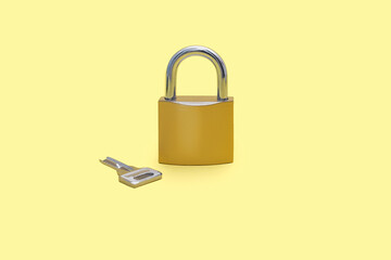 Padlock with a key on a yellow background. Gold color padlock with a silver key on a plain yellow...