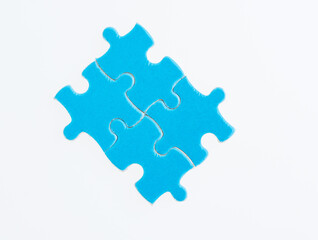Four blue puzzle pieces on white background
