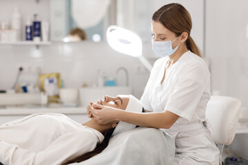 Doctor doing face massage and mask for skin