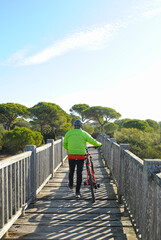 Fototapeta na wymiar Bay of Cadiz Natural Park, Andalusia, Spain. Bike tour on the bridge over the San Pedro River. Marshes of the Toruños and Pinar de la Algaida.