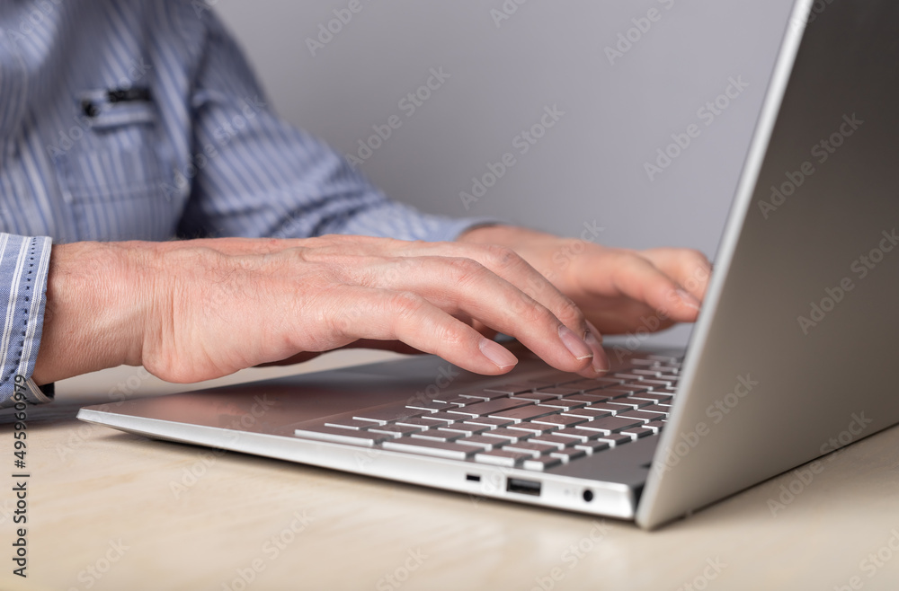 Poster man hands closeup typing on laptop keyboard. using computer for distant work, online education, soci