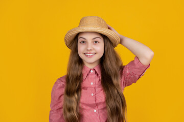 happy girl in straw hat on yellow background