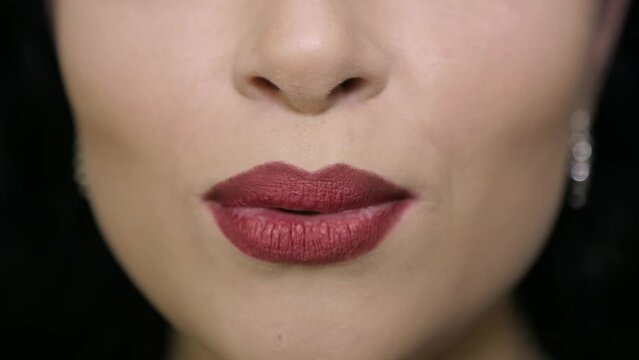 Girl with beautiful lips speaks to the camera
