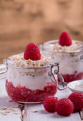 porridge with yoghurt and raspberries in jars