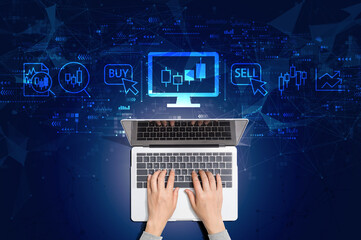 Stock trading theme with person using a laptop computer