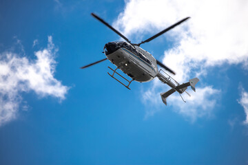Helicopter close-up against the sky. Rescue helicopter flies in the sky with clouds.