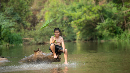 Happy Country Boy Smile Playing Water At The River InAsian.