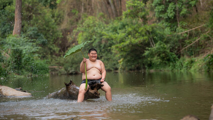 Happy Country Boy Smile Playing Water At The River InAsian.