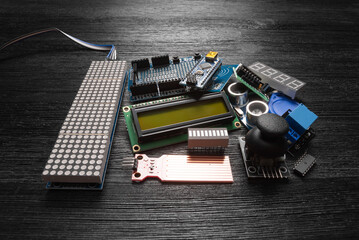 Microprocessor programming parts on the black table concept background.