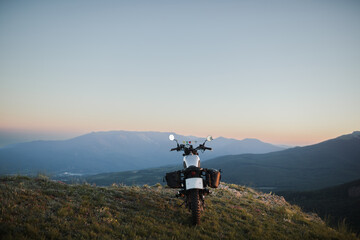 classic motorcycle in the mountains at sunset