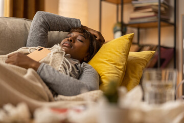 A dark-skinned woman lies in bed as prescribed by her doctor. The girl has struggled all night with...