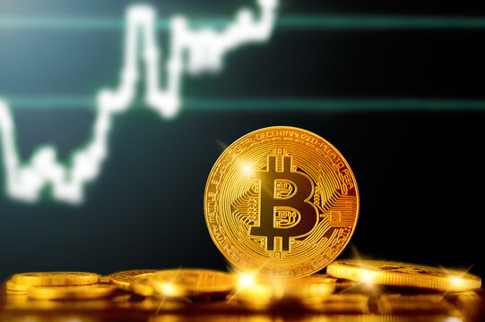 BITCOIN (BTC) cryptocurrency; BITCOIN golden coin on the background of the chart