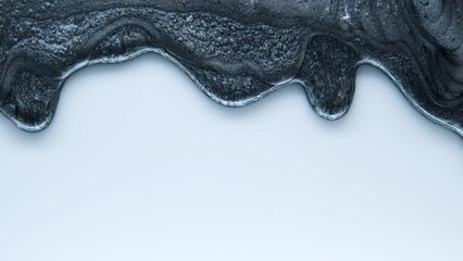 Black mother-of-pearl luminous liquid. Advertisement for minerals. Decorative cosmetics. Medical cosmetics for face and body.