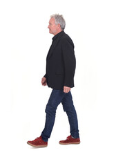 Naklejka premium side view of senior man walking on white background