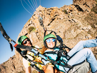 Happy tourist doing paragliding sport activity in outdoor leisure active lifestyle. Cheerful adult...