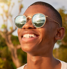 Now thats what I call a view. Shot of a happy young man wearing sunglasses while admiring the view...