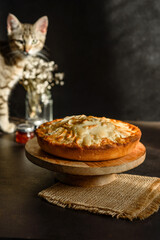 Apple pie with fresh fruits on a wooden table
