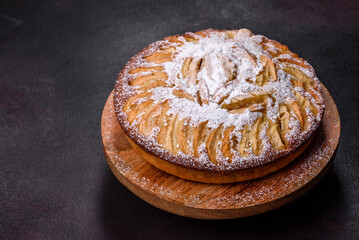 Apple pie with fresh fruits on a wooden table