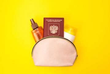 Tourism travel concept. Travel passport and cosmetic products for tanning or sun protection. Preparing for a sunny vacation