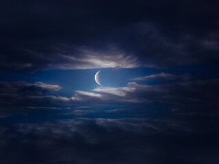 Moon in the night sky shines through dark clouds. Half moon with stars.