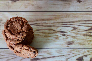 Zenith view, chocolate chip cookies, on wooden table and copy space.