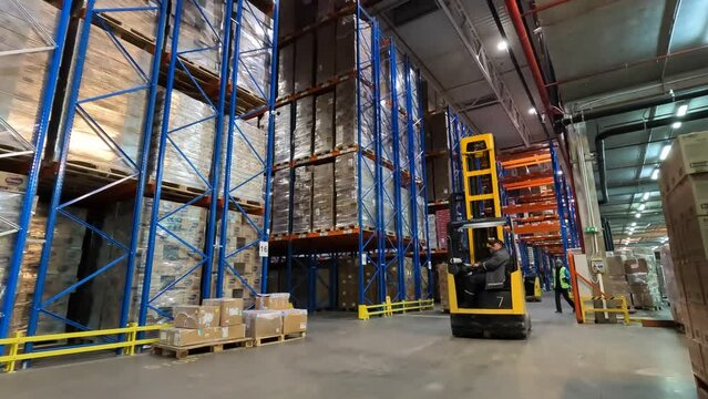 Active work in the warehouse. Modern forklift works in a warehouse. Work of special equipment in the warehouse. industrial interior. Forklift work in a warehouse.