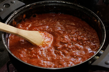 Cooking ground beef with tomato salsa.