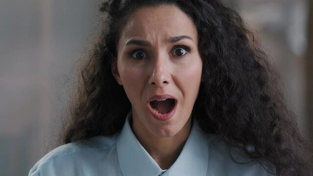 Amazed beautiful young arab business lady girl office worker surprised looking at camera making big eyes shocked by sudden victory close up shocked woman winner demonstrate wow emotion face expression