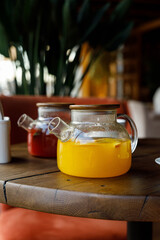 teapot with tea on a wooden table in a premium restaurant
