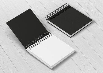 Black cover notepad isolated on wood background