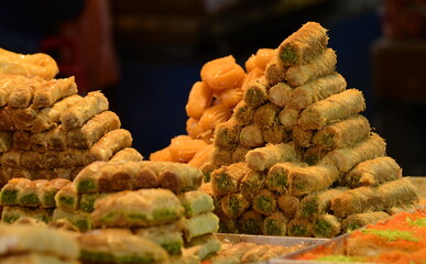 Arabic sweet baked goods. Variety of sweets on the arab street market stall. Eastern sweets in a...