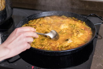 woman making paella at home