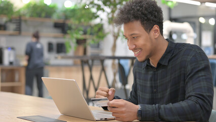 Successful Online Payment on Laptop by African American Man 