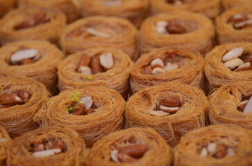 Baklava (modern Middle Eastern Arab-style dessert) baked with sugar and honey syrup, sweet and...