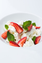 Breakfast strawberries with cottage cheese in a plate, food photography