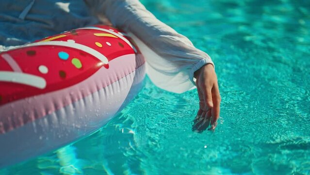 Woman floats on inflatable ring in the pool. Summer vacation concept.