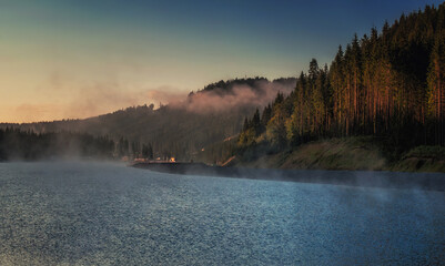 Fototapeta na wymiar mountain lake in morning light in Bukovel village, Carpathia, Ukraine