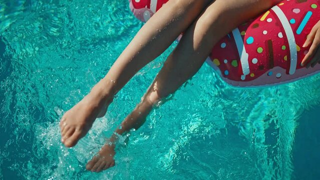 Woman legs in swimming pool. Summer vacation concept.