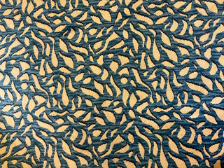 A blue and cream colored carpeted flooring that can be used as a background.
