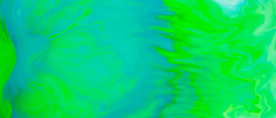 Fluid art background in green color. Green-turquoise stains on liquid. Creative background with blurred paints