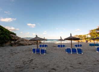 Fototapeta na wymiar Beach with white sand and turquoise water of the Mediterranean sea in Alcudia, Mallorca, or Majorca, Balearic Islands, Spain