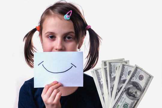 Conceptual image: making money and good business. Beautiful happy young girl holding US Dollar banknotes.