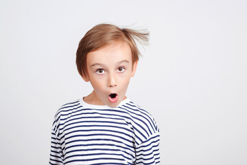 Shocked boy posing at studio. Children style and fashion. Face emotion and expression.