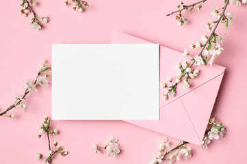 Blank greeting card mockup with envelope and white flowers