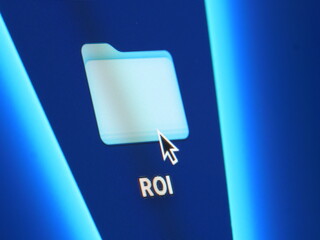 ROI - return on investment - macro shot of folder on computer desktop with mouse pointer - zooming in on screen pixels