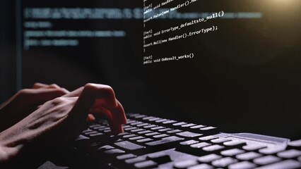 Close up of computer hacker hands typing 3D code virus PC on keyboard late night working. Programmer writing sites and programs. 3D future coding. High quality 4k footage