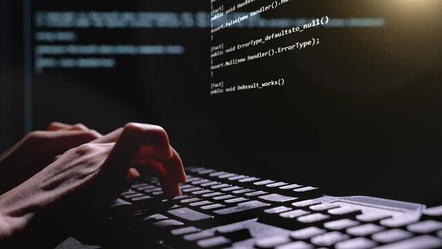 Close up of computer hacker hands typing 3D code virus PC on keyboard late night working. Programmer writing sites and programs. 3D future coding. High quality 4k footage