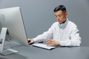 man in headphones at the table in front of the computer Lifestyle work